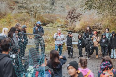 Group at the river led by an Elder