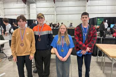 Four students with medals