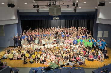large group of students gathered on stage