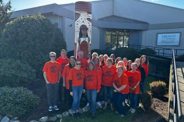 Staff wearing orange shirts