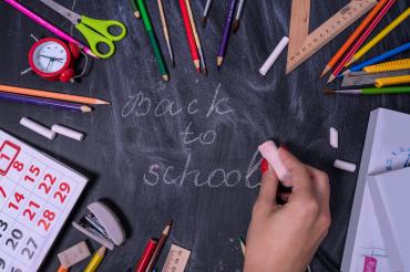 Hand writing Back to School on Chalkboard