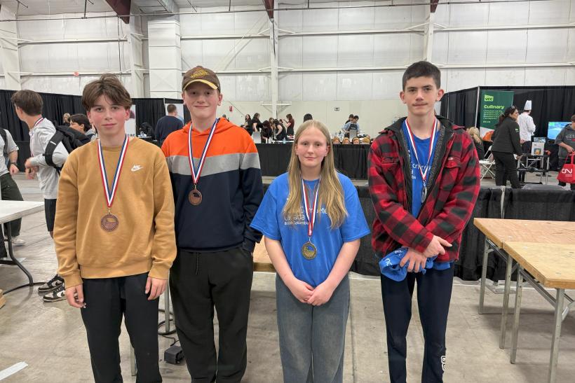 Four students with medals