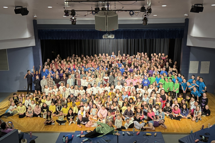 large group of students gathered on stage