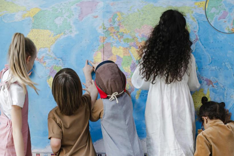 Children looking at world map